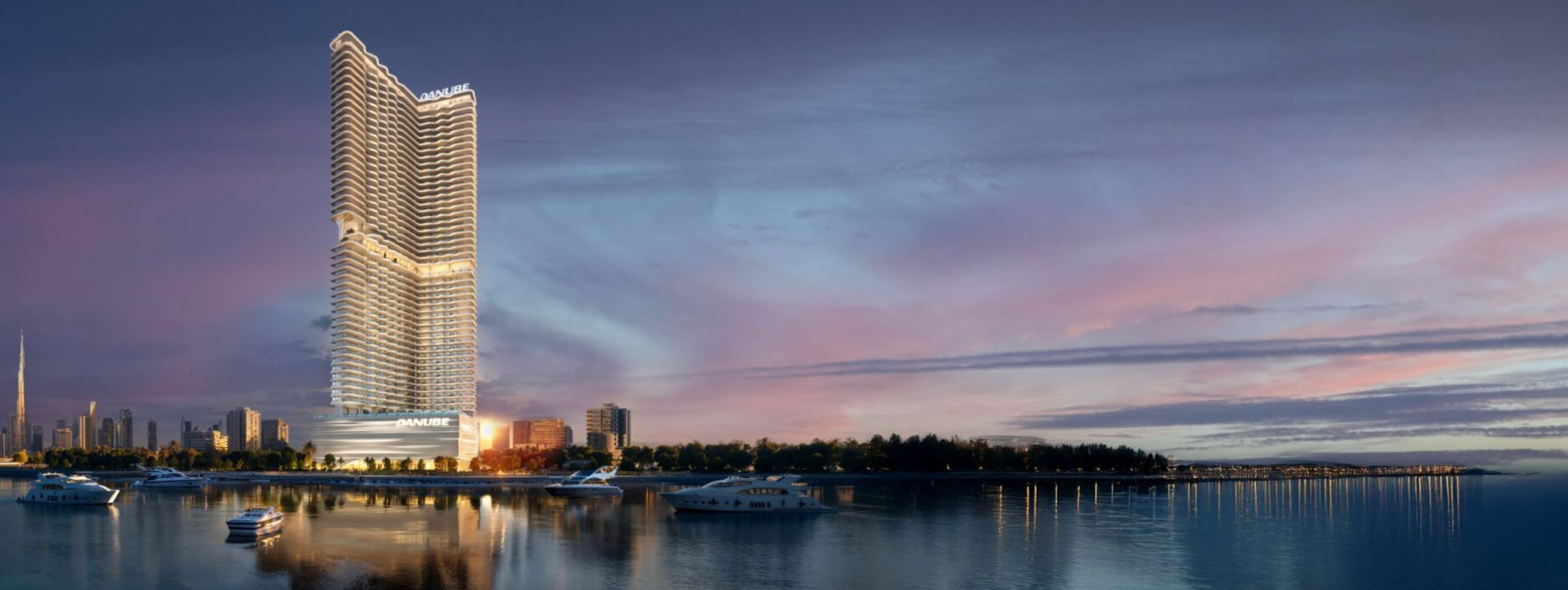 Night view of Breez tower from marina with Dubai skyline