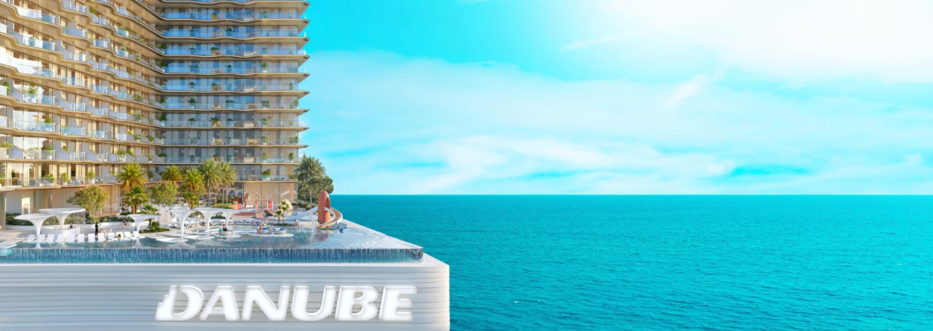 Infinity pool deck with Danube branding and ocean views